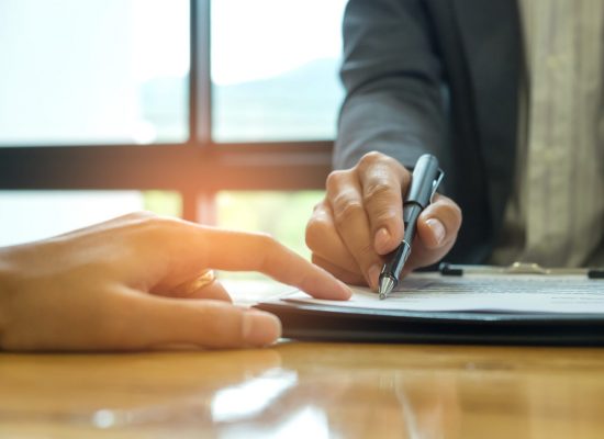 Business concept, signing a business contract,Businessmen holdin Business concept, signing a business contract,Businessmen holding pens are signing a contract.
